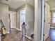 Well-lit hallway with hardwood floors, doors leading to various rooms, and a guitar at 2751 Davis Rd, Marietta, GA 30062