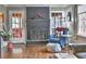 Cozy living room featuring a painted brick fireplace, hardwood floors, and comfortable blue armchair at 2751 Davis Rd, Marietta, GA 30062