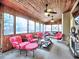 Beautiful sunroom with bright furniture, wood ceiling, fireplace and walls of windows overlooking the backyard at 2751 Davis Rd, Marietta, GA 30062