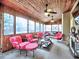 Inviting sunroom with wood-paneled walls, comfortable seating, ceiling fans and many windows providing an abundance of natural light at 2751 Davis Rd, Marietta, GA 30062