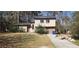 Shows the house and a yard filled with debris on a sunny day at 3005 Flat Shoals Rd, Atlanta, GA 30349