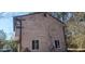 The side of the house and showing peeled paint, a window, and vines growing at 3005 Flat Shoals Rd, Atlanta, GA 30349