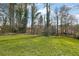 Large backyard with mature trees providing ample shade and privacy for outdoor activities at 921 Forest Park Ln, Suwanee, GA 30024