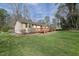 Expansive backyard featuring a wooden deck, ideal for enjoying the outdoors at 921 Forest Park Ln, Suwanee, GA 30024