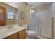 Bathroom featuring a glass shower door, wood-look flooring and a wood vanity with chrome hardware at 921 Forest Park Ln, Suwanee, GA 30024