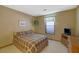 Neutral bedroom featuring a window, plaid bedspread, and carpet flooring at 921 Forest Park Ln, Suwanee, GA 30024