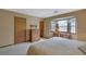 Bedroom features a bay window, desk, and neutral carpet at 921 Forest Park Ln, Suwanee, GA 30024