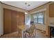 Eat-in kitchen dining area with a table, wooden chairs, and a storage closet at 921 Forest Park Ln, Suwanee, GA 30024