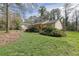 A beautiful lawn accents this lovely home with mature trees, offering a picturesque setting at 921 Forest Park Ln, Suwanee, GA 30024