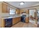 Traditional kitchen with stainless steel appliances, wooden cabinets, and a double sink at 921 Forest Park Ln, Suwanee, GA 30024