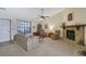 Cozy living room features a fireplace, neutral carpet, and plenty of natural light at 921 Forest Park Ln, Suwanee, GA 30024