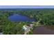 Aerial view of lake, pool, and clubhouse surrounded by lush greenery in the community at 100 Silverbell Ct, Roswell, GA 30075