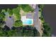 Overhead aerial shot of a pool with turquoise water located near a lake at 100 Silverbell Ct, Roswell, GA 30075