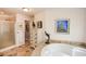 Bathroom featuring a walk-in shower and a standalone tub with unique tile design at 100 Silverbell Ct, Roswell, GA 30075