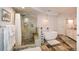 Open-concept bathroom with a stone shower, free-standing bathtub and tiled flooring at 100 Silverbell Ct, Roswell, GA 30075