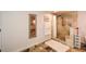 Bathroom with stone shower, fluffy rug and a view of bathtub and vanity at 100 Silverbell Ct, Roswell, GA 30075