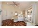 Bright bedroom with hardwood floors, ceiling fan, and natural light at 100 Silverbell Ct, Roswell, GA 30075