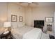 Bedroom featuring wood floors, ceiling fan, and unique wall decor at 100 Silverbell Ct, Roswell, GA 30075