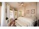 This bedroom features a queen-sized bed, a ceiling fan, and a bright window with white curtains at 100 Silverbell Ct, Roswell, GA 30075