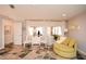 Bright bedroom boasts a sitting area with chairs, tiled floors, and natural light at 100 Silverbell Ct, Roswell, GA 30075