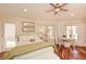 Bright bedroom featuring hardwood floors, a ceiling fan, and large windows with natural light at 100 Silverbell Ct, Roswell, GA 30075