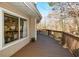 Spacious outdoor deck with wood railing overlooks the wooded backyard, offering tranquil views at 100 Silverbell Ct, Roswell, GA 30075