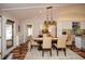 Dining area adjacent to the kitchen, featuring hardwood floors, a wood table and views to the outside at 100 Silverbell Ct, Roswell, GA 30075