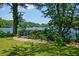 Scenic lake view featuring a charming dock surrounded by lush greenery at 100 Silverbell Ct, Roswell, GA 30075