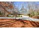 Inviting home exterior, with a circular design, surrounded by mature trees and a well-maintained lawn at 100 Silverbell Ct, Roswell, GA 30075