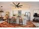 A kitchen with white cabinets, a stainless steel fridge, and a large island with seating at 100 Silverbell Ct, Roswell, GA 30075