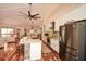 Bright kitchen with stainless steel appliances and an island overlooking the living space at 100 Silverbell Ct, Roswell, GA 30075