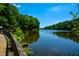 A tranquil lake view showcases the natural beauty and scenic boardwalk of the community at 100 Silverbell Ct, Roswell, GA 30075