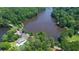 Scenic aerial view captures a tranquil lake surrounded by verdant forests and neighborhood amenities at 100 Silverbell Ct, Roswell, GA 30075