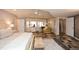 Sunlit bedroom with stone tile flooring, chair sitting area, and white curtains at 100 Silverbell Ct, Roswell, GA 30075