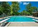 Outdoor pool with diving boards and lifeguard chairs is an excellent summer feature at 100 Silverbell Ct, Roswell, GA 30075