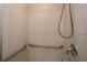 Shower featuring tiled walls, a shower head, grab bars, and storage at 100 Silverbell Ct, Roswell, GA 30075