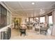 Inviting sunroom with ample seating, ceiling fan, and natural light, perfect for relaxation at 100 Silverbell Ct, Roswell, GA 30075