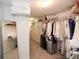 Walk-in closet with an organized rack of clothing and mirrored wall at 100 Silverbell Ct, Roswell, GA 30075