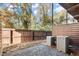 Private backyard with wood fence features pea gravel and two Lennox air conditioning units at 2333 Mason Dr # D26, Atlanta, GA 30316