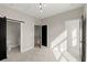 Bedroom featuring barn door access to bathroom, modern light fixture, and natural light at 2333 Mason Dr # D26, Atlanta, GA 30316