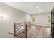 Upstairs hallway with hardwood floors, black doors, and wood and metal railing detail at 2333 Mason Dr # D26, Atlanta, GA 30316