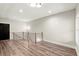 Upstairs hallway with hardwood floors, black doors, and wood and metal railing detail at 2333 Mason Dr # D26, Atlanta, GA 30316