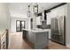 Modern kitchen featuring gray island, stainless steel appliances, and unique pendant lighting at 2333 Mason Dr # D26, Atlanta, GA 30316