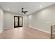 Sun-drenched living room with hardwood floors and black French doors at 2333 Mason Dr # D26, Atlanta, GA 30316