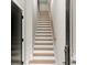 Stairway with wood treads and white risers, leading to the upper level, and side lighting at 2333 Mason Dr # D26, Atlanta, GA 30316