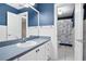 Stylish blue bathroom with white cabinets, a walk-in shower, and tiled floor at 2778 Macland Rd, Dallas, GA 30157