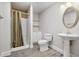 Cozy bathroom with a shower and a pedestal sink and cabinet storage at 2778 Macland Rd, Dallas, GA 30157