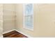 Walk-in closet featuring hardwood floors, wire shelving, and a window for natural light at 2778 Macland Rd, Dallas, GA 30157