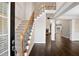 Elegant foyer featuring hardwood floors, a staircase with iron railings, and an open layout at 2778 Macland Rd, Dallas, GA 30157