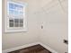 Laundry room featuring hardwood floors, a window for natural light and a wire rack shelving at 2778 Macland Rd, Dallas, GA 30157